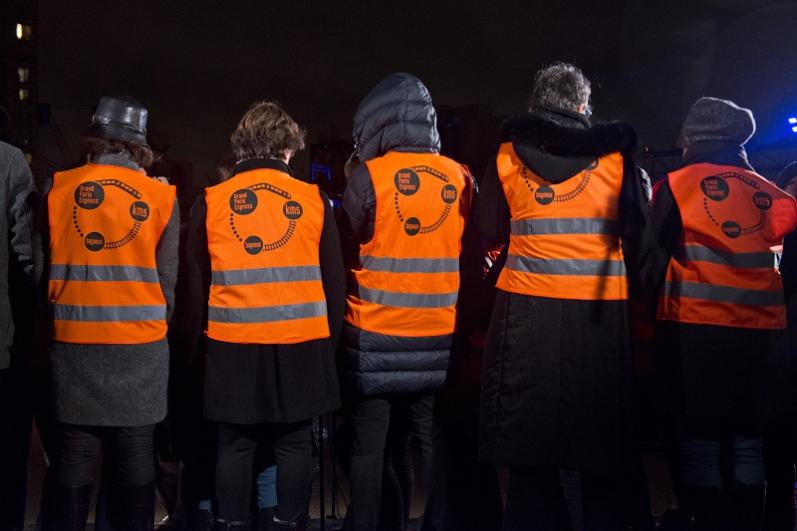 Cinq personnes de dos en gilets oranges de chantier lors du KM5 à Bagneux
