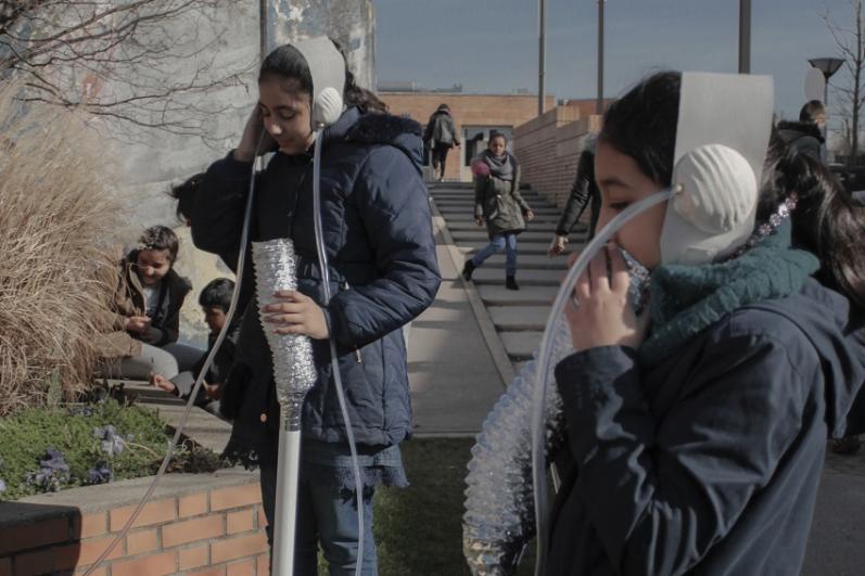 Deux enfants avec des casques d’écoute, en espace public, dans le cadre du chantier partagé du collectif COAL à Châtillon-Montrouge
